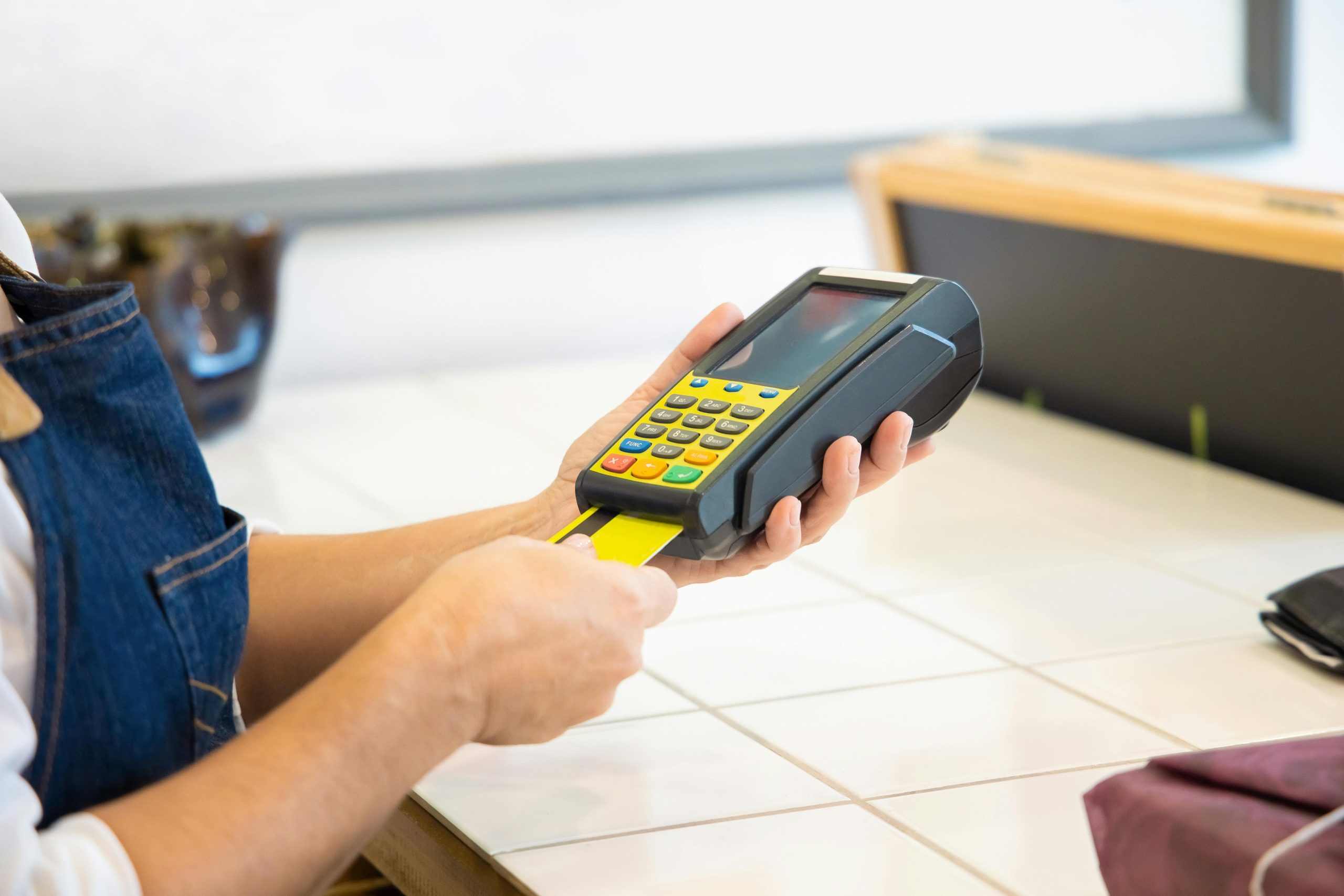 https://www.pexels.com/photo/a-person-holding-a-pos-machine-6023605/