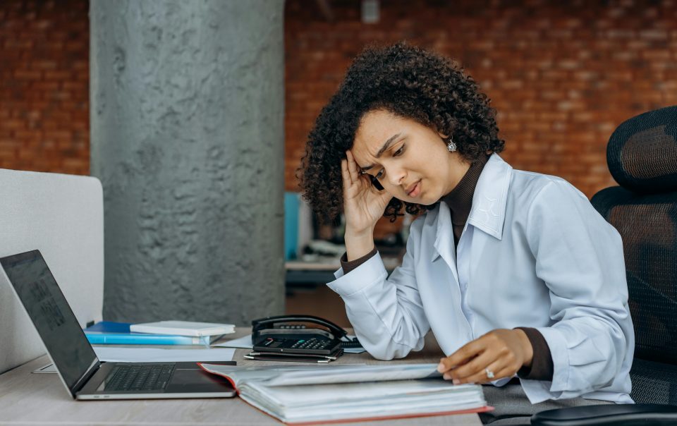 An Exhausted Woman Reading Accounting Documents