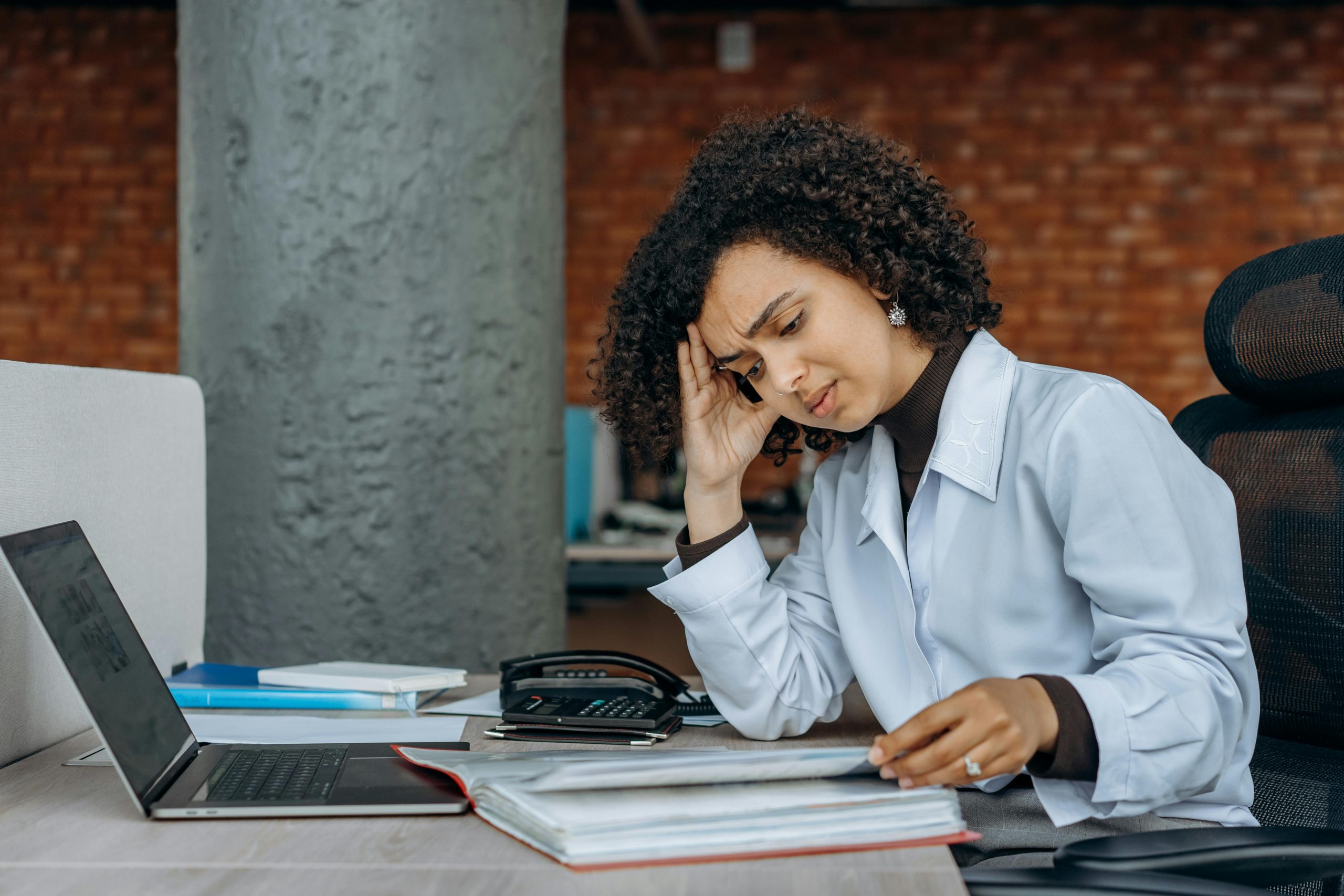 An Exhausted Woman Reading Accounting Documents