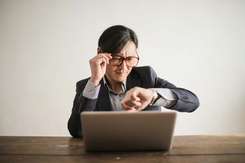 Man Inside an Office Checking His Wristwatch