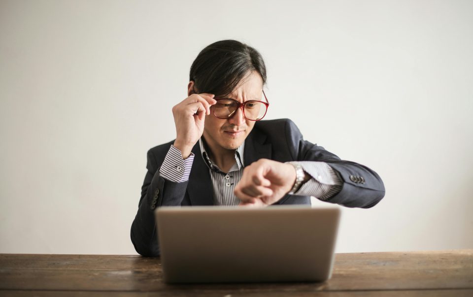 Man Inside an Office Checking His Wristwatch